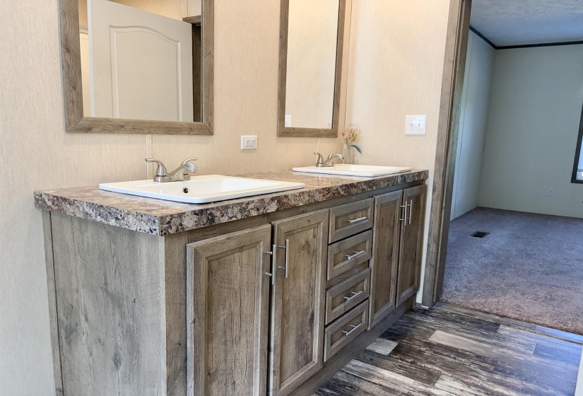 Double vanity with wood-finish cabinetry and silver hardware