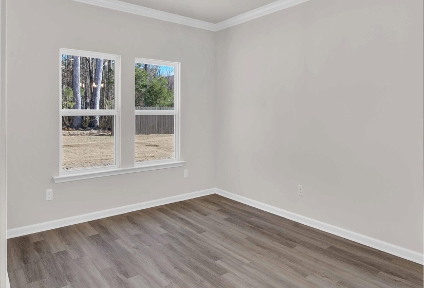 Unfurnished room featuring wood finished floors and crown molding