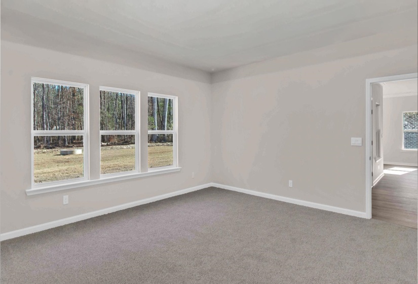 Spare room with dark colored carpet and healthy amount of natural light