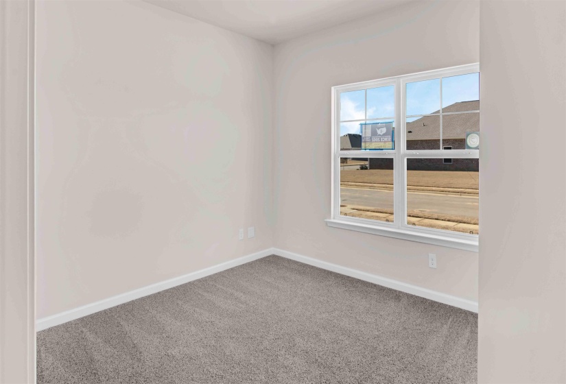 Carpeted empty room with baseboards