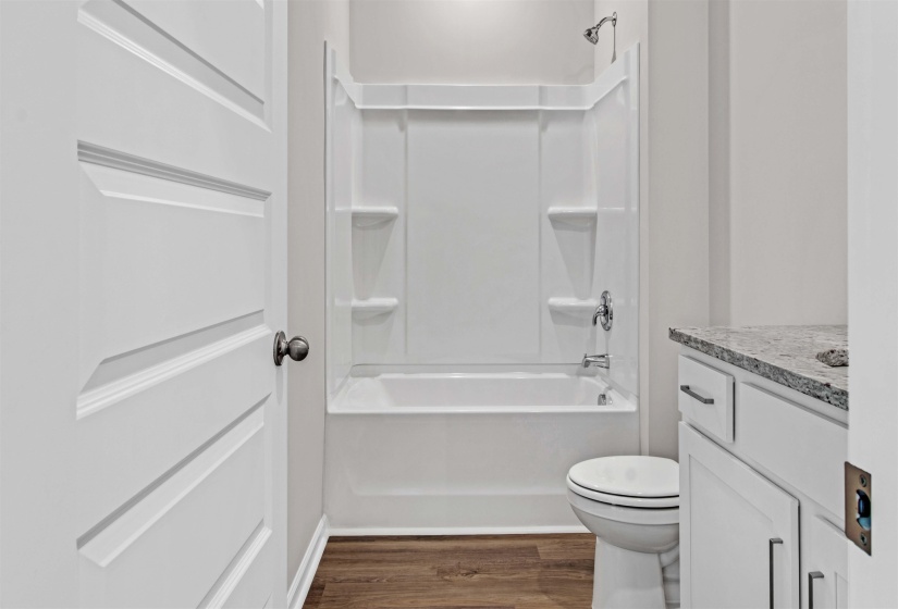 Full bathroom featuring vanity, dark wood-style flooring, and  shower combination