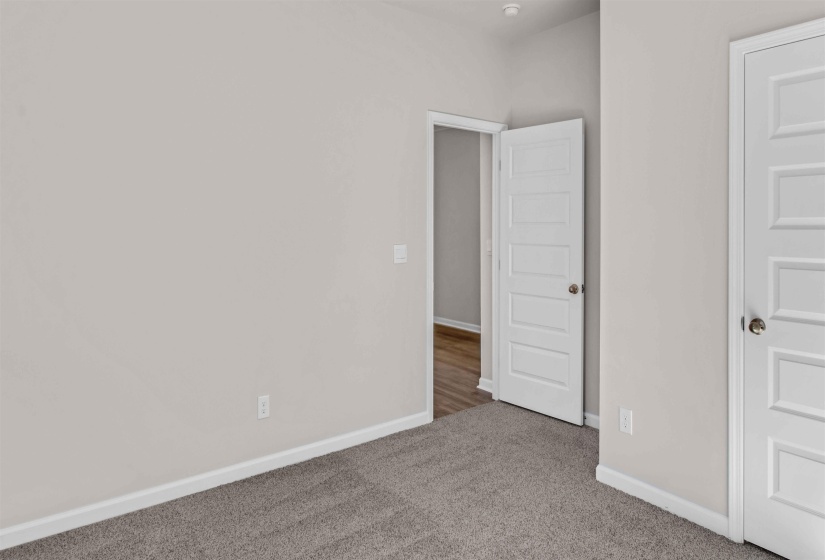 Unfurnished bedroom featuring baseboards and carpet flooring