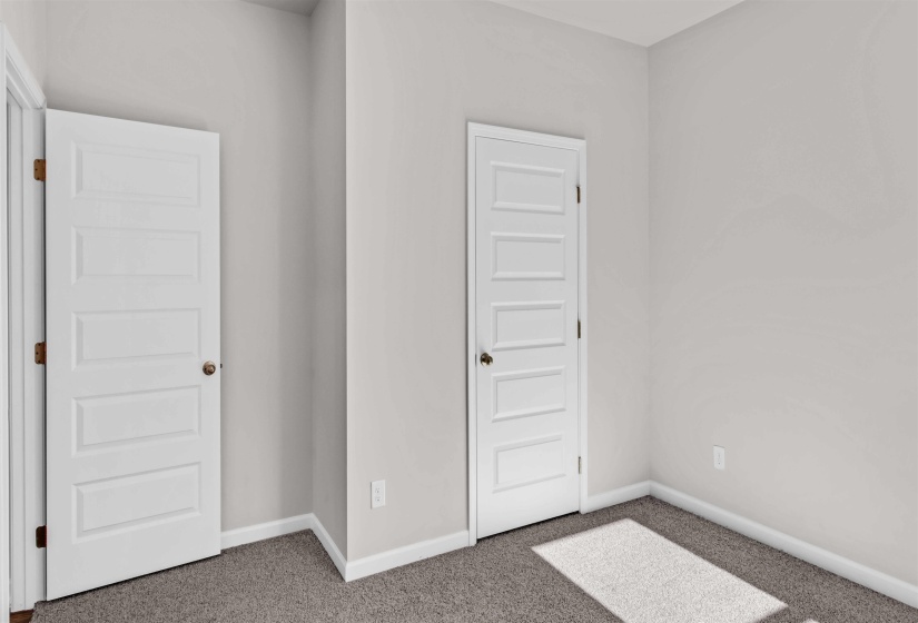 Unfurnished bedroom with carpet and baseboards