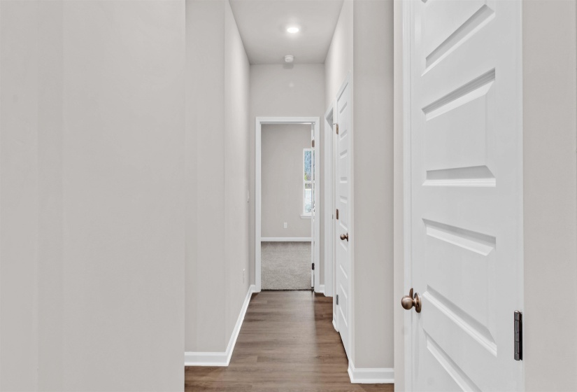 Corridor with baseboards and wood finished floors