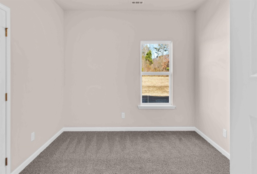 Spare room with baseboards and carpet flooring
