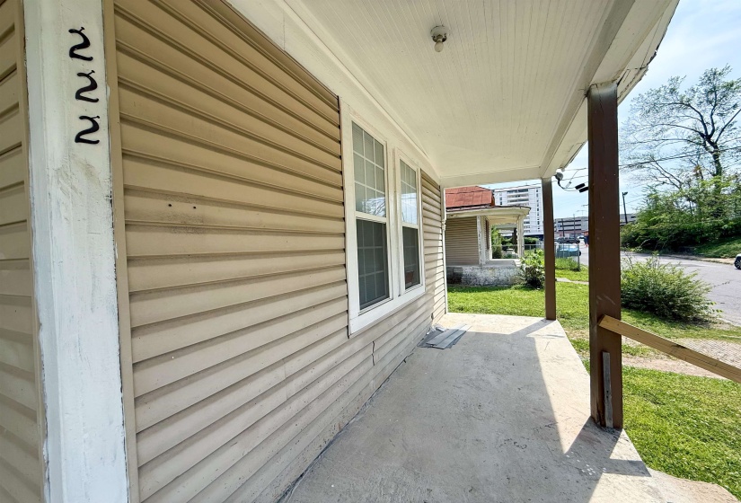 Covered front porch with a concrete surface