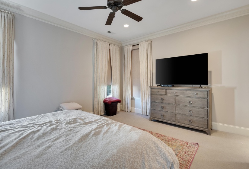 Spacious room featuring multiple windows with drapery, recessed lighting, crown molding, and a ceiling fan