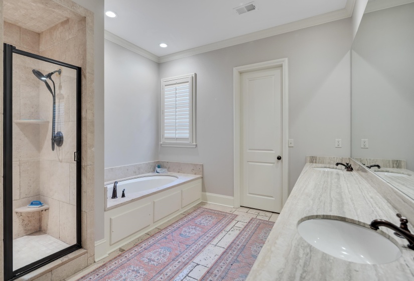 Bathroom featuring a glass-enclosed shower with tiled walls and a built-in shelf