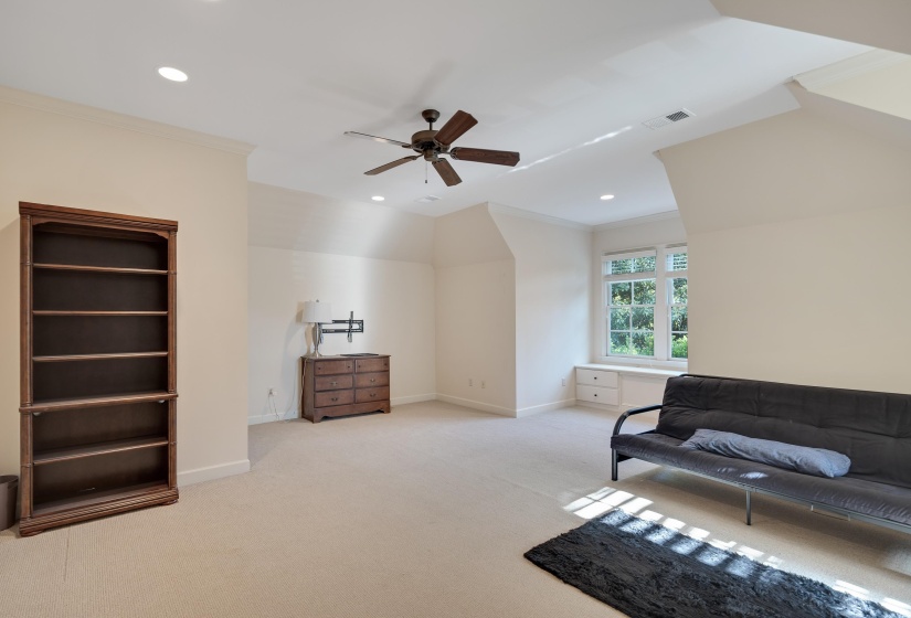 Spacious room featuring carpeting, recessed lighting, a ceiling fan, and a built-in window seat with storage