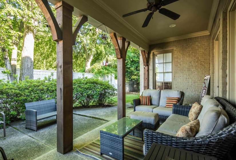 Covered patio featuring robust timber columns, a ceiling fan, and recessed lighting