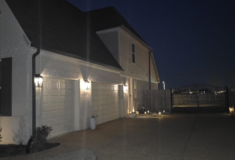 White brick exterior with dark shutters and a dark roof