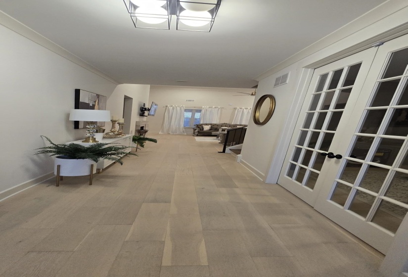 Light wood-finish flooring extending through the hallway