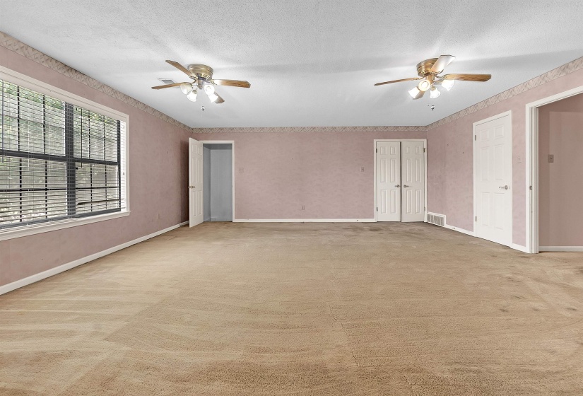 Spacious room featuring neutral carpeting and multiple entry points