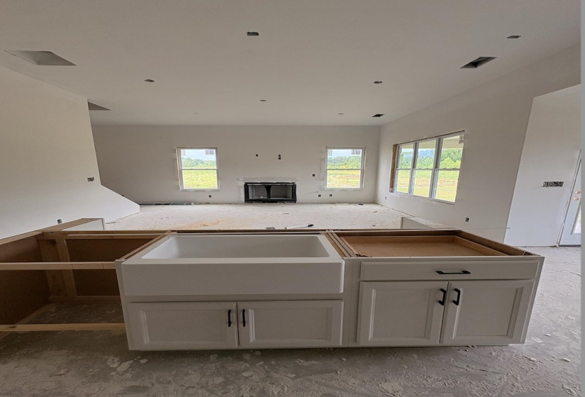 Kitchen island base with white cabinetry and dark hardware