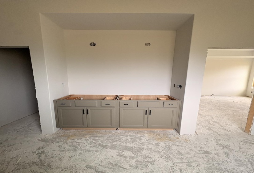 Built-in cabinetry featuring a neutral finish and black hardware, designed for a double vanity installation