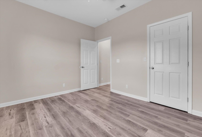 Neutral-toned walls complement wood-finish flooring in this room