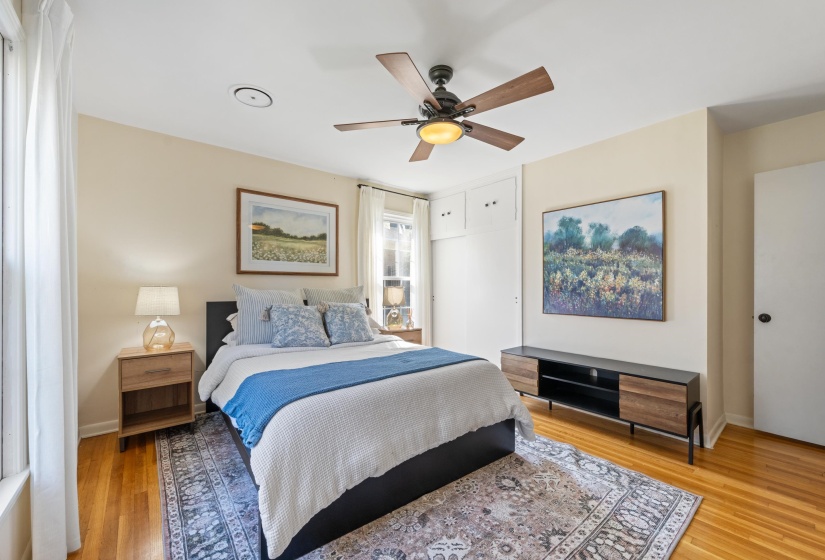 Bedroom with ceiling fan and light wood-type flooring