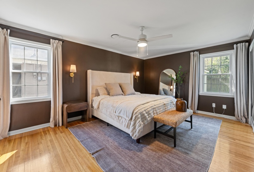 Bedroom with ornamental molding, light wood-type flooring, and a ceiling fan