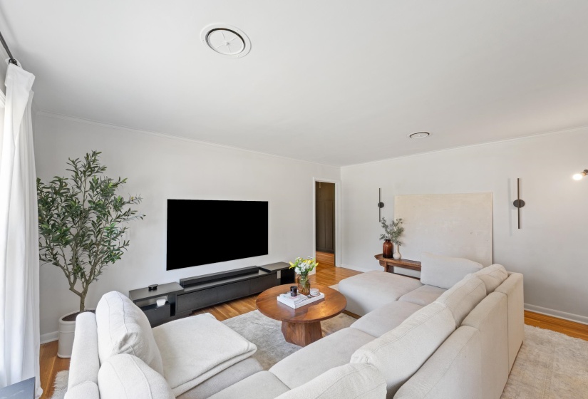 Living area featuring baseboards and light wood finished floors