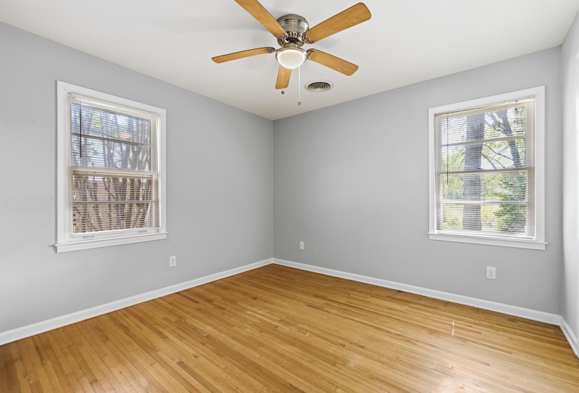 Hardwood flooring complemented by light gray walls and white trim