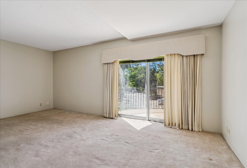 Spacious room featuring neutral carpeting and light-toned walls