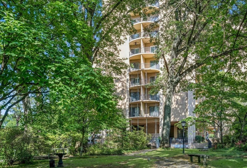 Multi-story building featuring a series of circular balconies with glass railings