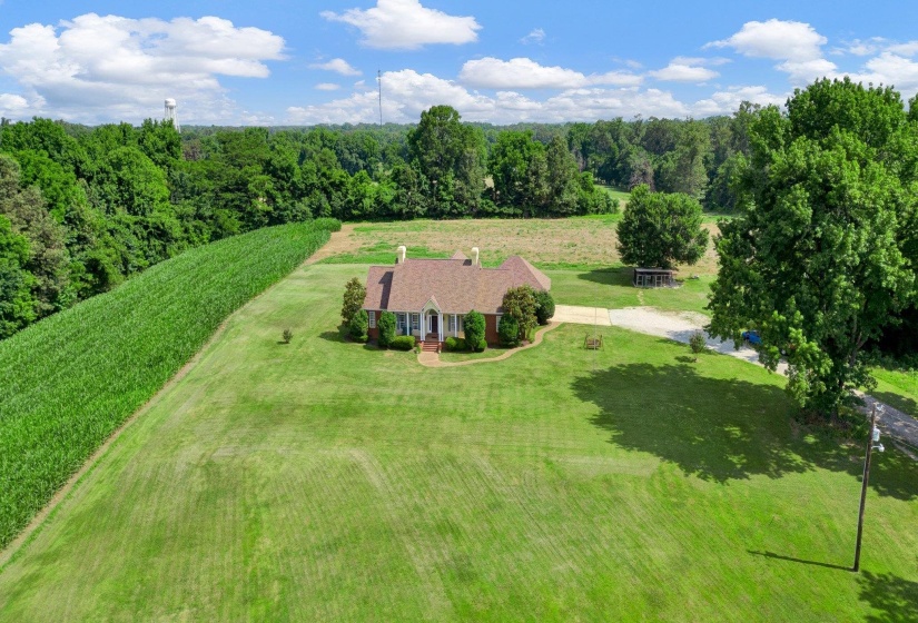 Brick residence surrounded by a large manicured lawn