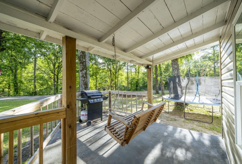 Covered porch with concrete flooring and wood railing