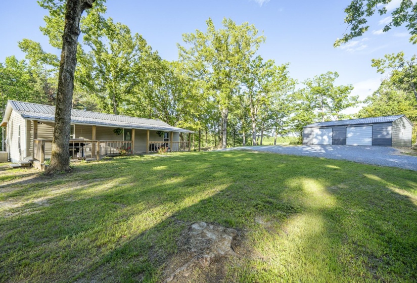 Single-story residence featuring a covered front porch with wood railings and a metal roof