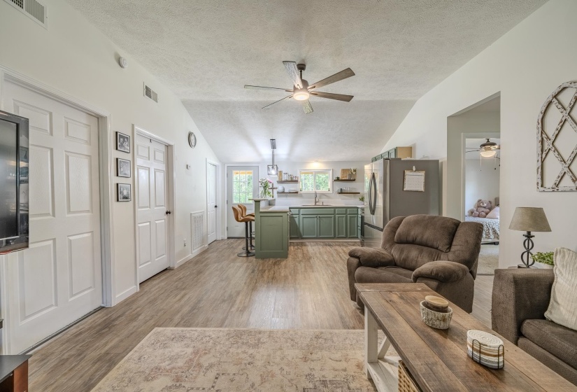 Vaulted ceiling living space with wood-finish flooring