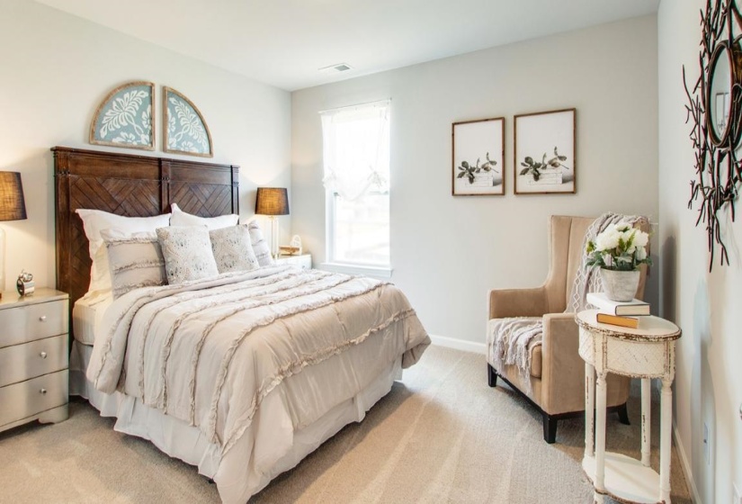 Bedroom featuring light carpet