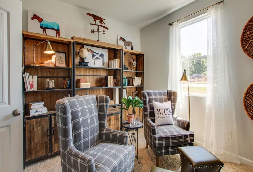 Sitting room featuring light carpet