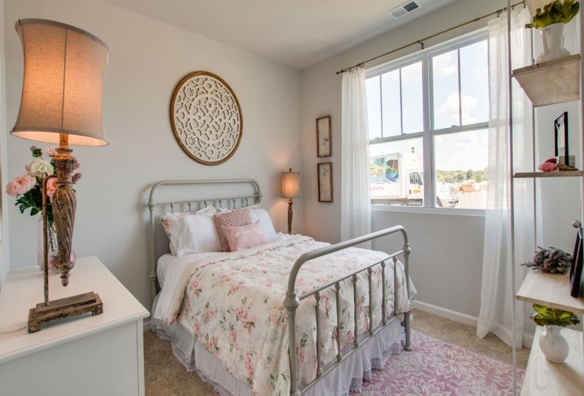 Bedroom with light colored carpet