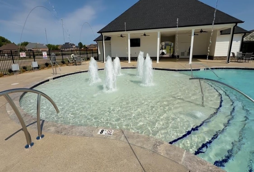 Community pool featuring a ceiling fan and a patio