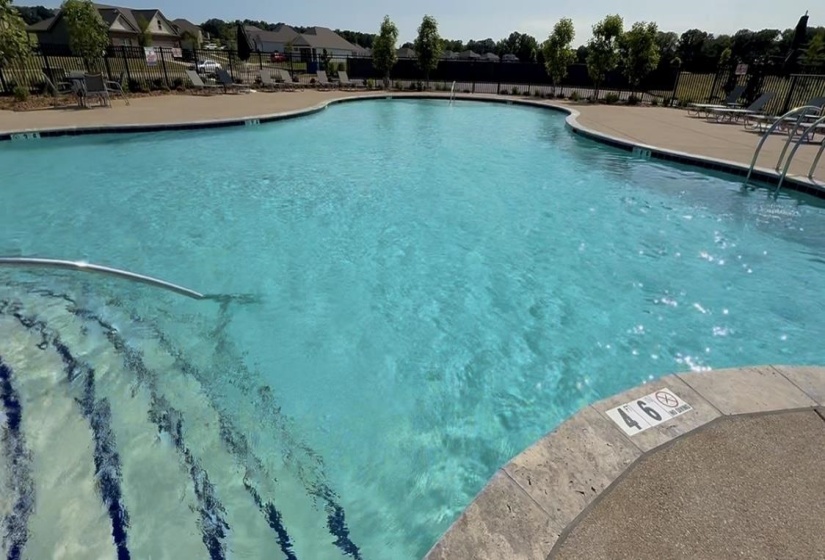 Community pool featuring a patio area and a residential view