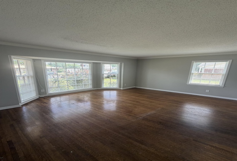 Spacious room featuring rich wood-finish flooring