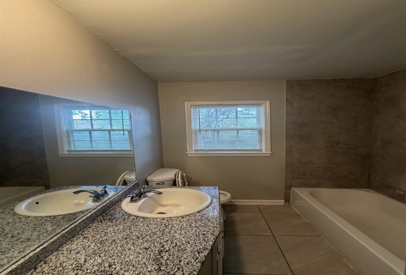 Double vanity with stone-finish countertop and undermount sinks
