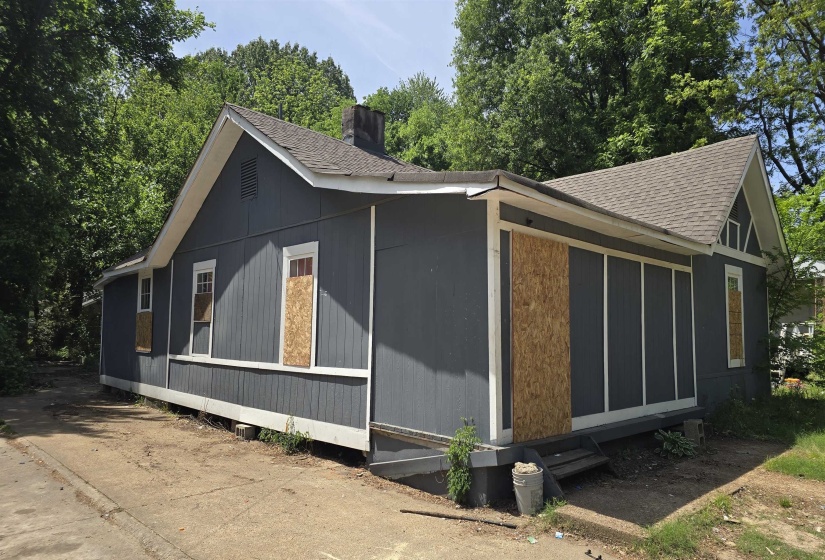 Single-story residential structure featuring dark gray siding and white trim