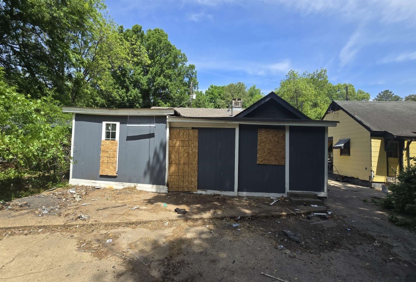 Single-story structure featuring dark gray siding and a light-colored foundation