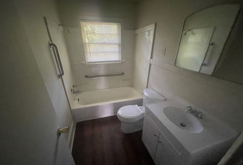 Bathroom with a single vanity, integrated sink, and white cabinetry