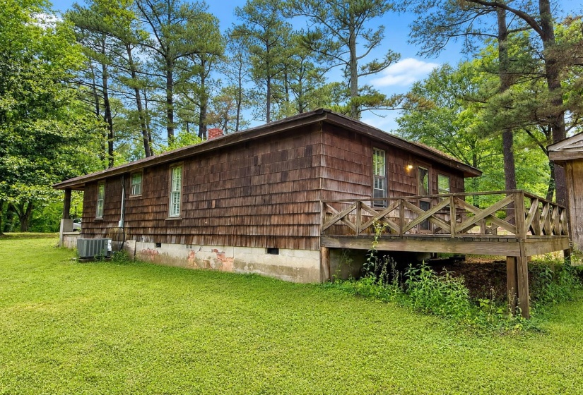 Wood-shingle exterior featuring a raised wooden deck with railing
