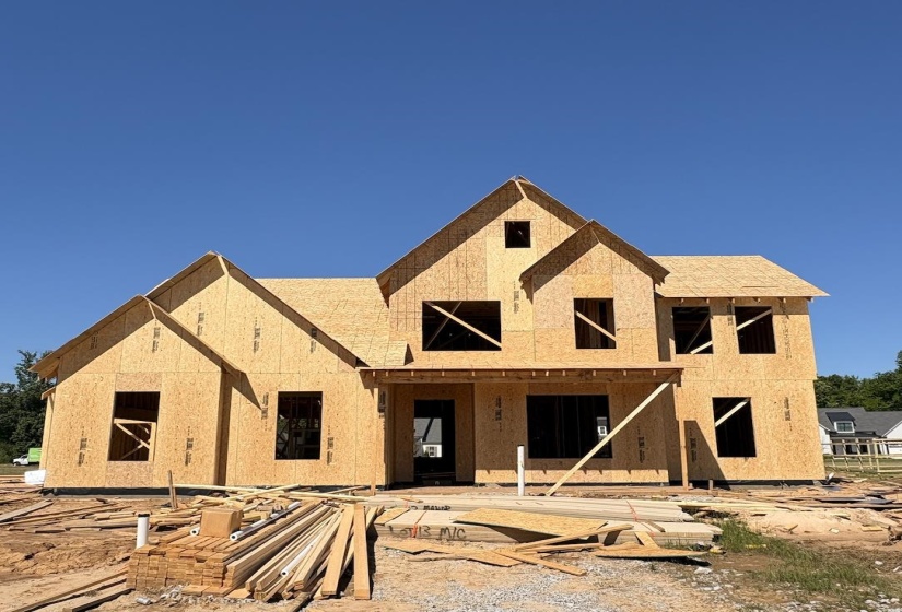 Newly constructed frame home featuring multiple gables and varied rooflines