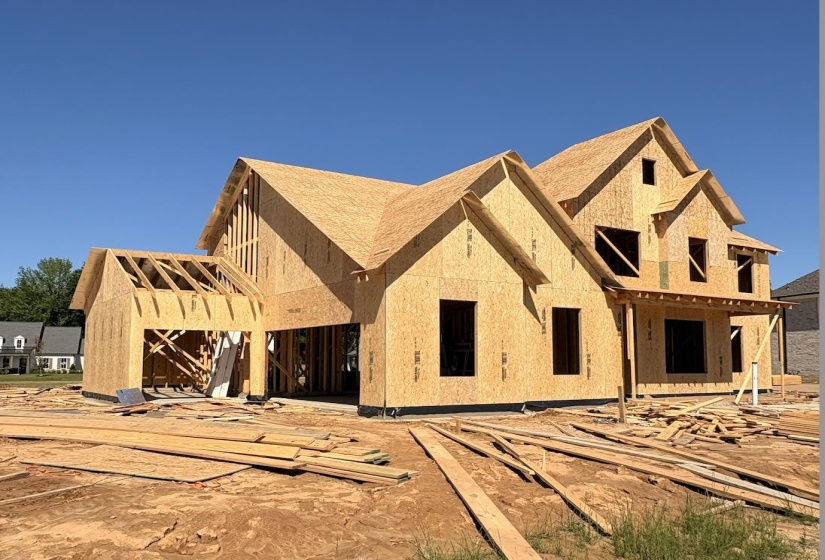 New construction home framed with oriented strand board sheathing and a multi-pitch roofline