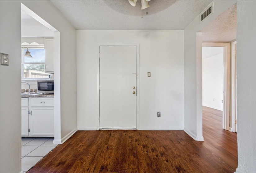 Interior space featuring wood-finish flooring, white walls, and a white ceiling
