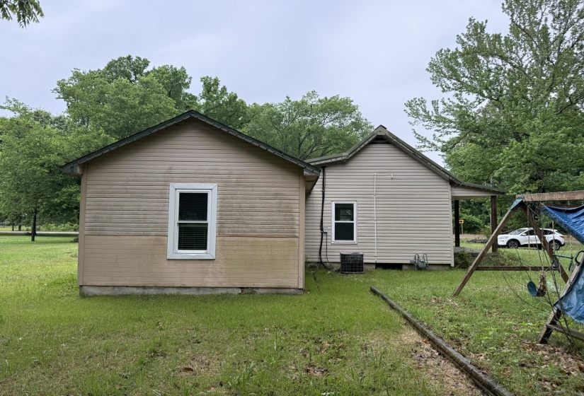 Property exterior featuring horizontal siding and multiple windows