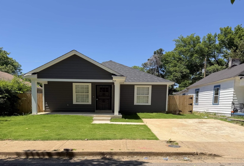 Charcoal gray siding with white trim and a gabled roofline