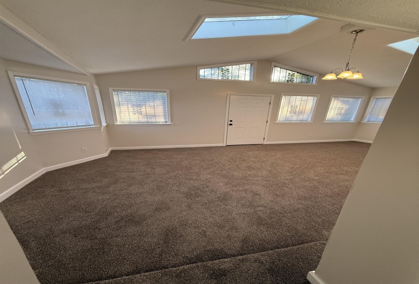 Vaulted ceiling with multiple skylights and transom windows