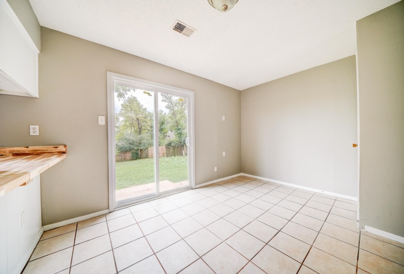 Empty room featuring light tile patterned floors and baseboards