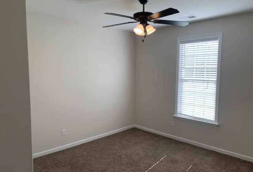 Unfurnished room featuring ceiling fan, baseboards, visible vents, and carpet floors