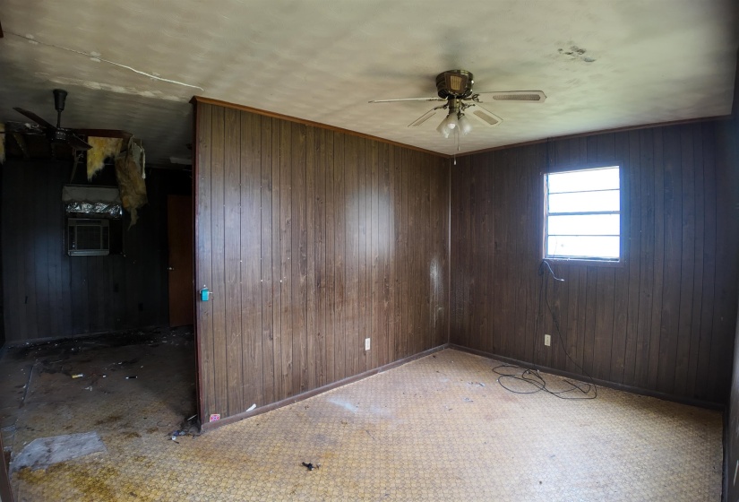 Interior space featuring wood paneling walls and patterned flooring
